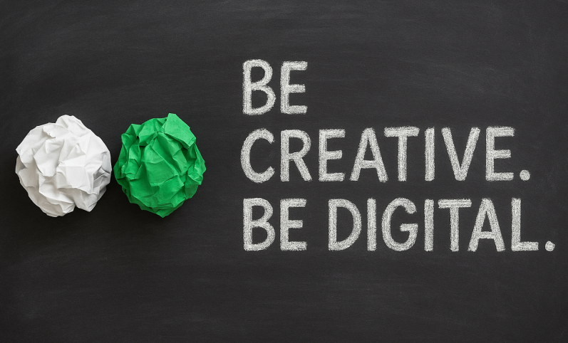 Zwei Papierknäuel und der Text "Sei kreativ. Sei digital." auf schwarzem Hintergrund.